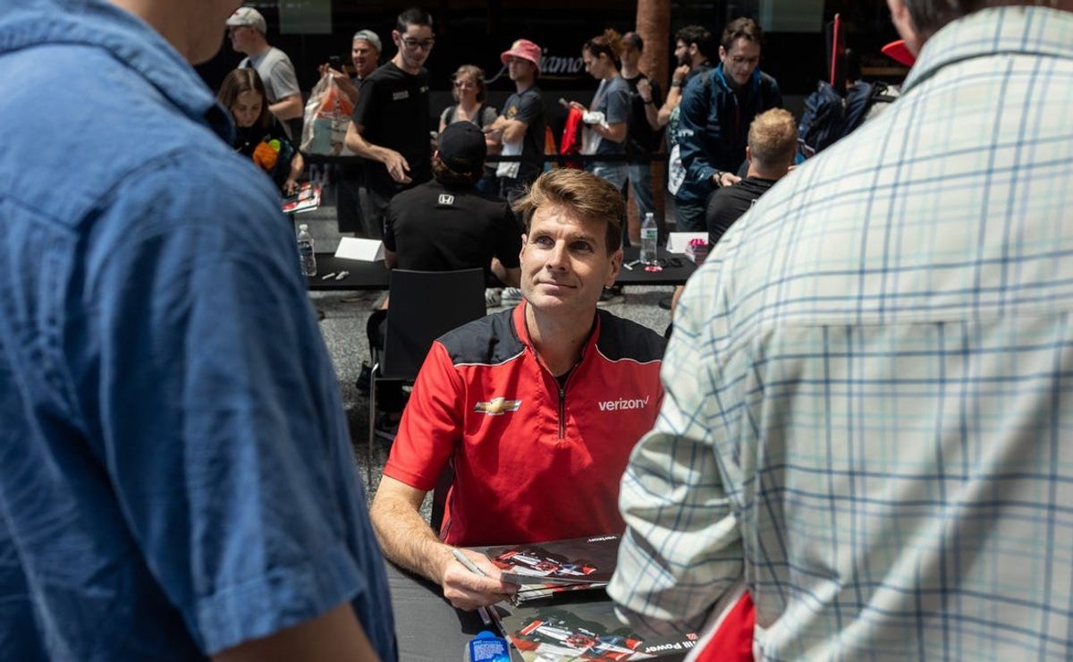 Will Power looks up at a couple of fans during the NTT IndyCar Series Driver's Autograph Session at the 2024 Detroit Grand Prix presented by Lear Free Prix Day inside the GM Renaissance Center in Detroit on Friday, May 31, 2024.