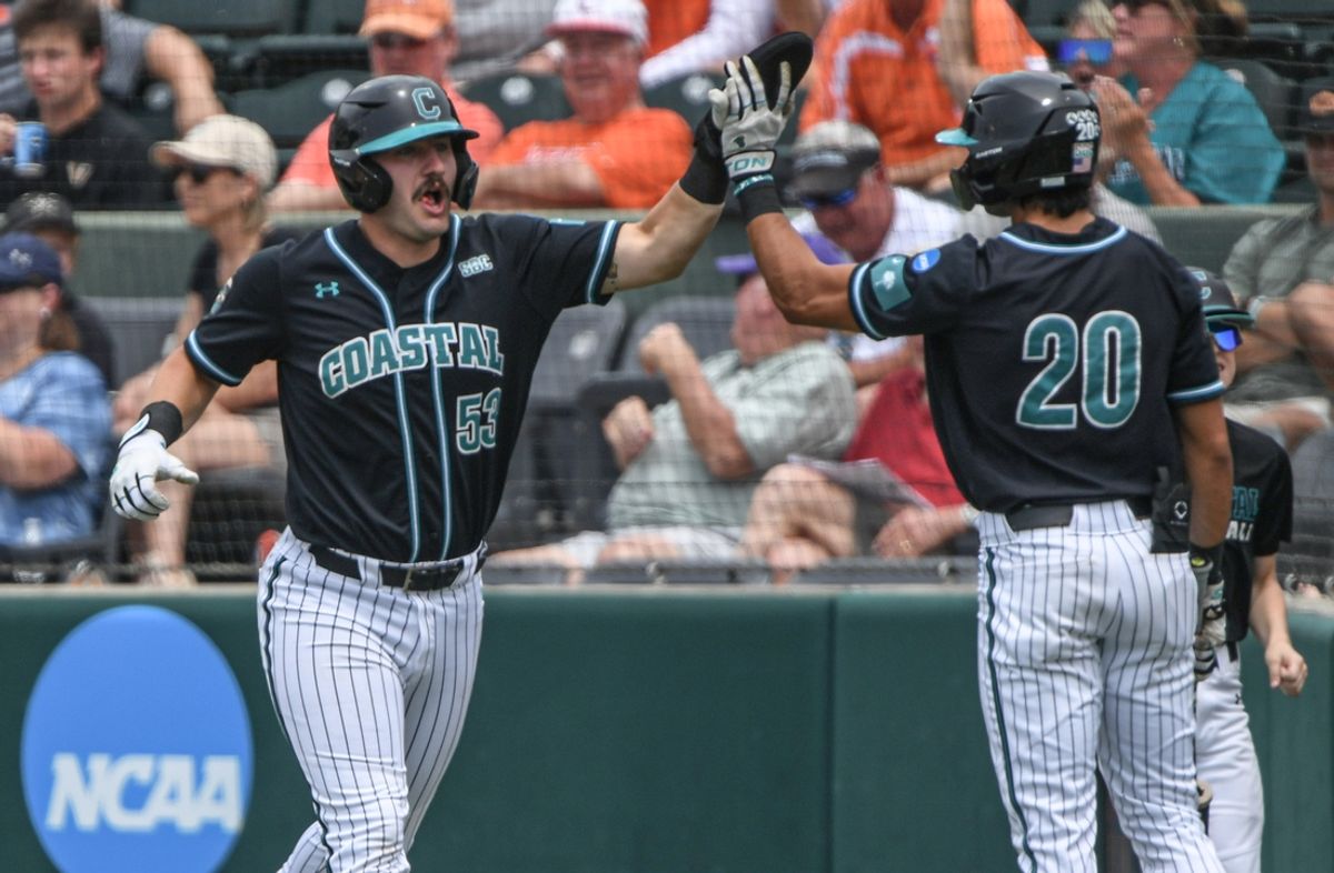 May 31, 2024; Clemson, SC, USA; Coastal Carolina junior Derek Bender (53) is congratulated by senior Corey Zientek (20) for scoring during the top of the second inning against Vanderbilt during the NCAA Clemson Regional baseball game at Doug Kingsmore Stadium. Mandatory Credit: Ken Ruinard-Imagn Images