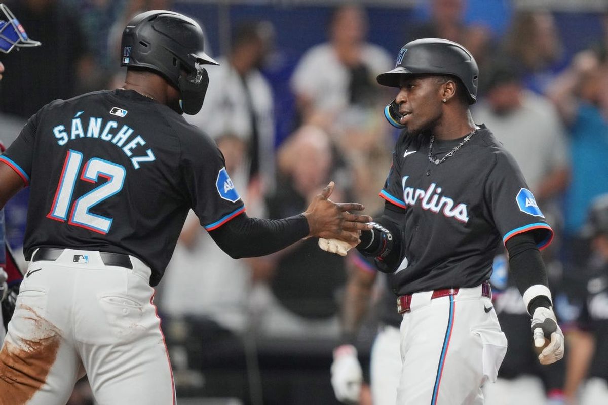 May 31, 2024; Miami, Florida, USA;  Miami Marlins left fielder Nick Gordon (1) is congratulated by right fielder Jesús Sánchez (12) after hitting a two-run home run against the Texas Rangers in the second inning at loanDepot Park. Mandatory Credit: Jim Rassol-USA TODAY Sports