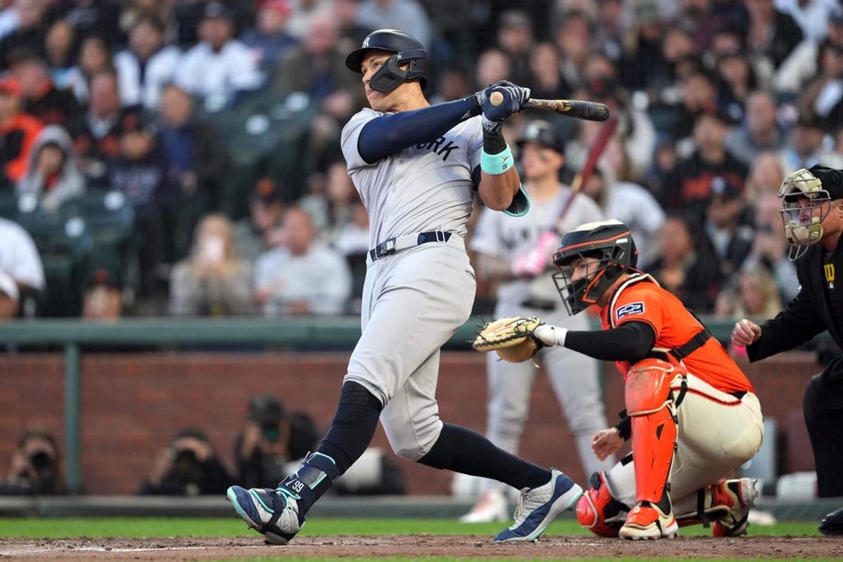 May 31, 2024; San Francisco, California, USA; New York Yankees designated hitter Aaron Judge (center) hits a home run against the San Francisco Giants during the third inning at Oracle Park. Mandatory Credit: Darren Yamashita-USA TODAY Sports