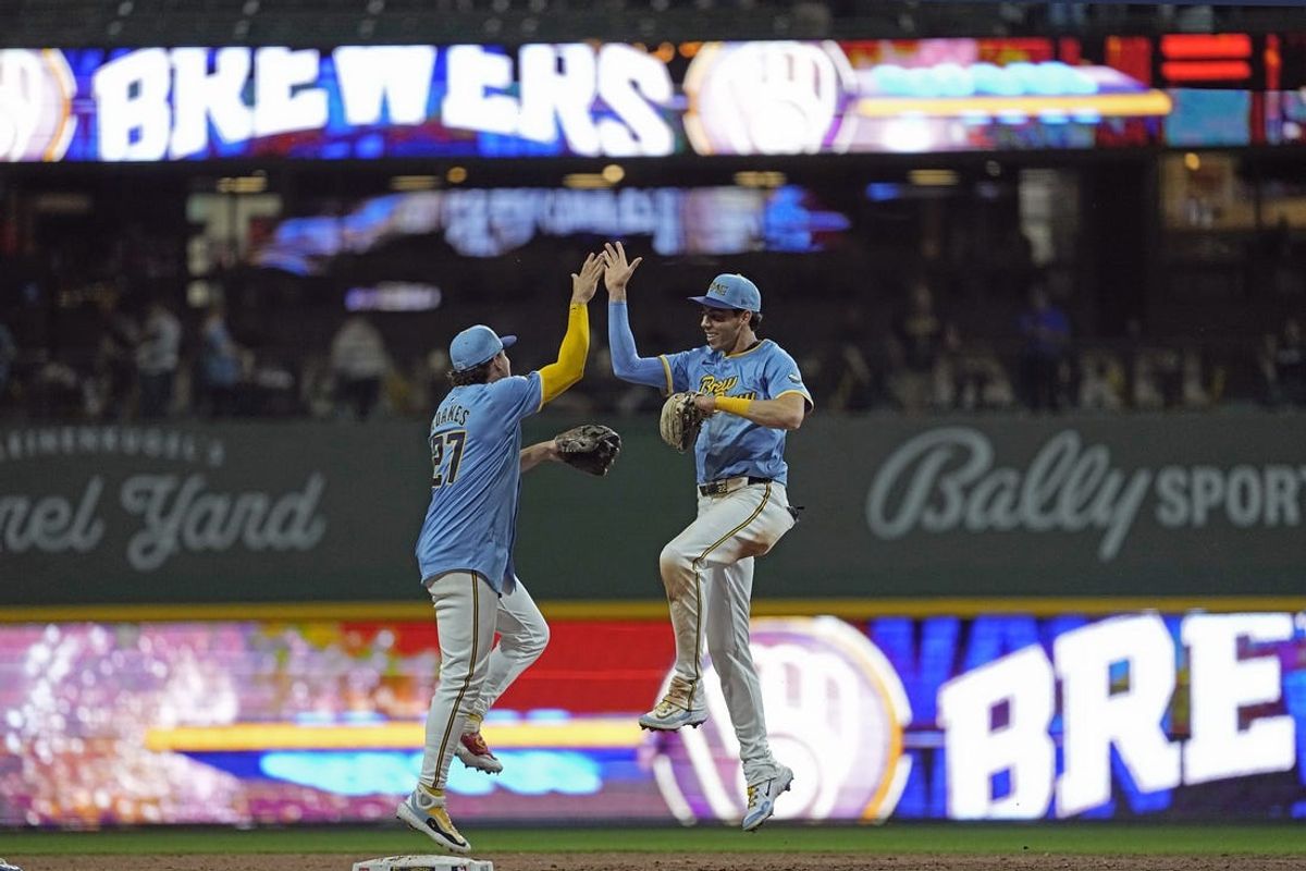 May 31, 2024; Milwaukee, Wisconsin, USA;  Milwaukee Brewers left fielder Christian Yelich (22) high fives shortstop Willy Adames (27) following the game against the Chicago White Sox at American Family Field. Mandatory Credit: Jeff Hanisch-USA TODAY Sports