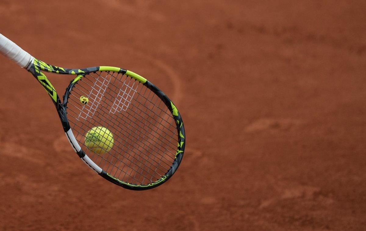 Jun 1, 2024; Paris, France; Ball on the racket of Felix Auger-Aliassime of Canada during his match against Ben Shelton of the United States on day seven of Roland Garros at Stade Roland Garros. Mandatory Credit: Susan Mullane-Imagn Images