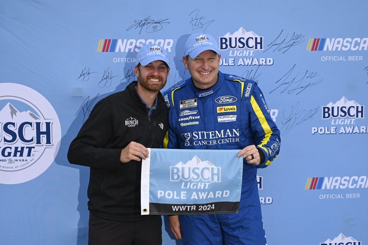Jun 1, 2024; Madison, Illinois, USA; NASCAR Cup Series driver Michael McDowell (34) poses for a photo after winning the Busch Light Pole Award during qualifying at World Wide Technology Raceway. Mandatory Credit: Joe Puetz-USA TODAY Sports