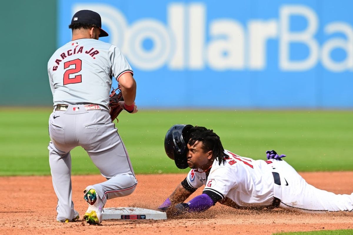 Jun 1, 2024; Cleveland, Ohio, USA; Cleveland Guardians third baseman Jose Ramirez (11) steals second as Washington Nationals second baseman Luis Garcia Jr. (2) waits for the throw during the third inning at Progressive Field. Mandatory Credit: Ken Blaze-USA TODAY Sports