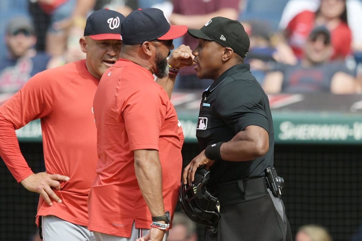 Jun 1, 2024; Cleveland, Ohio, USA; Washington Nationals manager Dave Martinez, middle, argues with umpire Malachi Moore after center fielder Jacob Young (not pictured) was called out on strikes during the second inning against the Cleveland Guardians at Progressive Field. Mandatory Credit: Ken Blaze-USA TODAY Sports