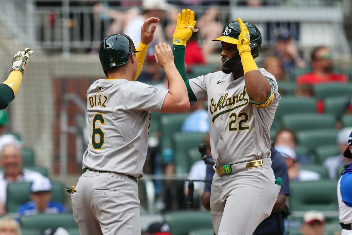 Jun 1, 2024; Atlanta, Georgia, USA; Oakland Athletics left fielder Miguel Andujar (22) celebrates with first baseman Aledmys Diaz (6) after a three-run home run against the Atlanta Braves in the second inning at Truist Park. Mandatory Credit: Brett Davis-USA TODAY Sports