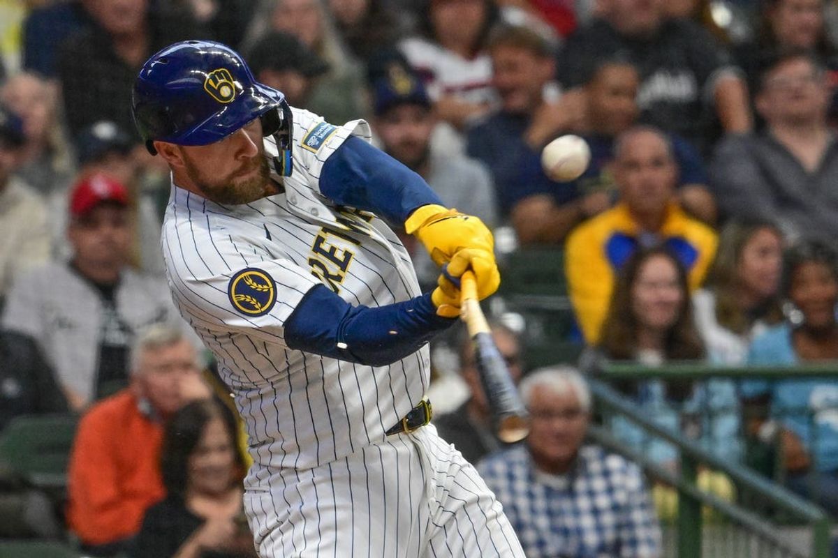 Jun 1, 2024; Milwaukee, Wisconsin, USA; Milwaukee Brewers first baseman Rhys Hoskins (12) breaks his bat while hitting a bloop single against the Chicago White Sox in the sixth inning at American Family Field. Mandatory Credit: Benny Sieu-USA TODAY Sports