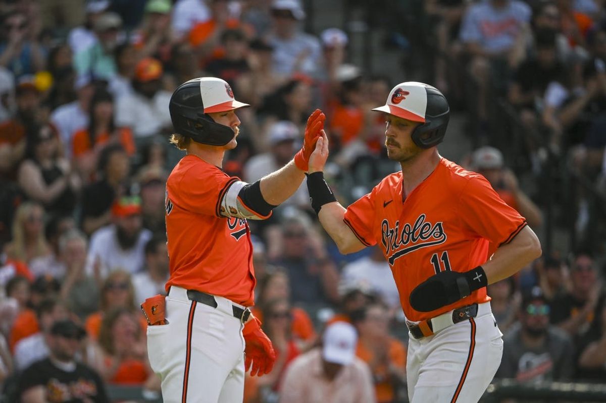 Jun 1, 2024; Baltimore, Maryland, USA;  Baltimore Orioles third baseman Jordan Westburg (11) high fives Baltimore Orioles shortstop Gunnar Henderson (2) after scoring during the third inning at Oriole Park at Camden Yards. Mandatory Credit: Tommy Gilligan-USA TODAY Sports