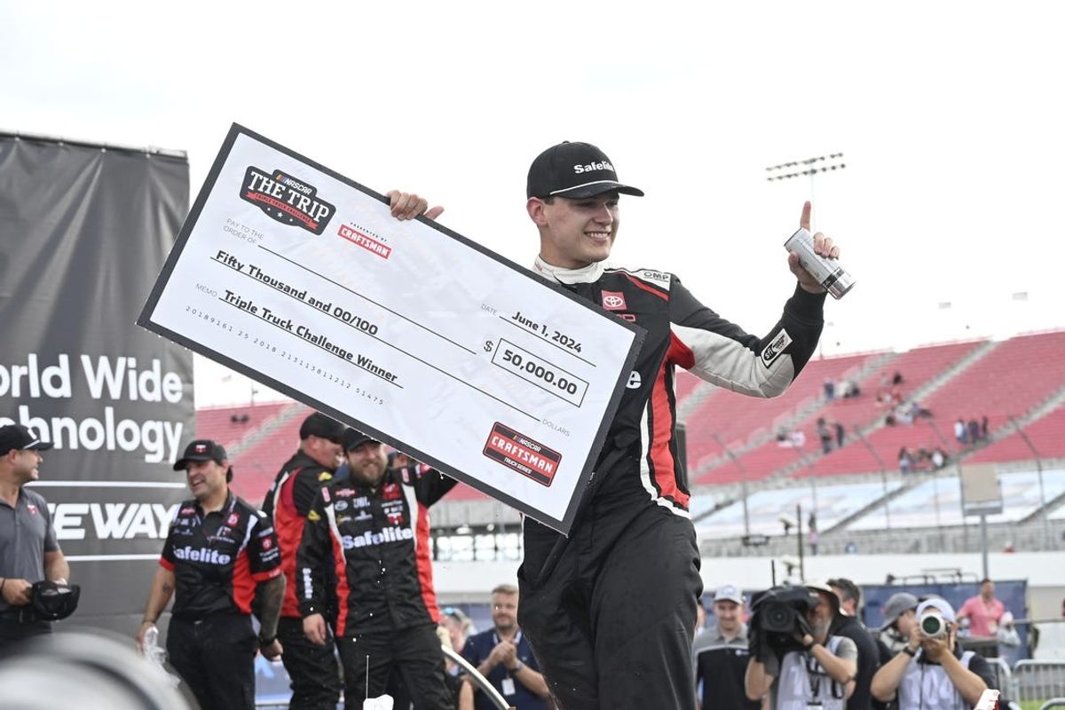 Jun 1, 2024; Madison, Illinois, USA; NASCAR Craftsman Truck Series driver Corey Heim (11) poses for a picture with a check after winning the NASCAR: Truck Series - Toyota 200 at World Wide Technology Raceway. Mandatory Credit: Joe Puetz-USA TODAY Sports