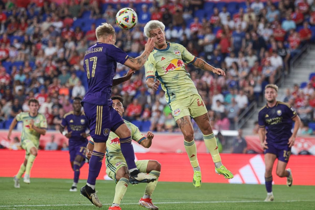 Jun 1, 2024; Harrison, New Jersey, USA; New York Red Bulls defender John Tolkin (47) and Orlando City midfielder Dagur Thorhallsson (17) battle for the ball during the first half at Red Bull Arena. Mandatory Credit: Vincent Carchietta-USA TODAY Sports