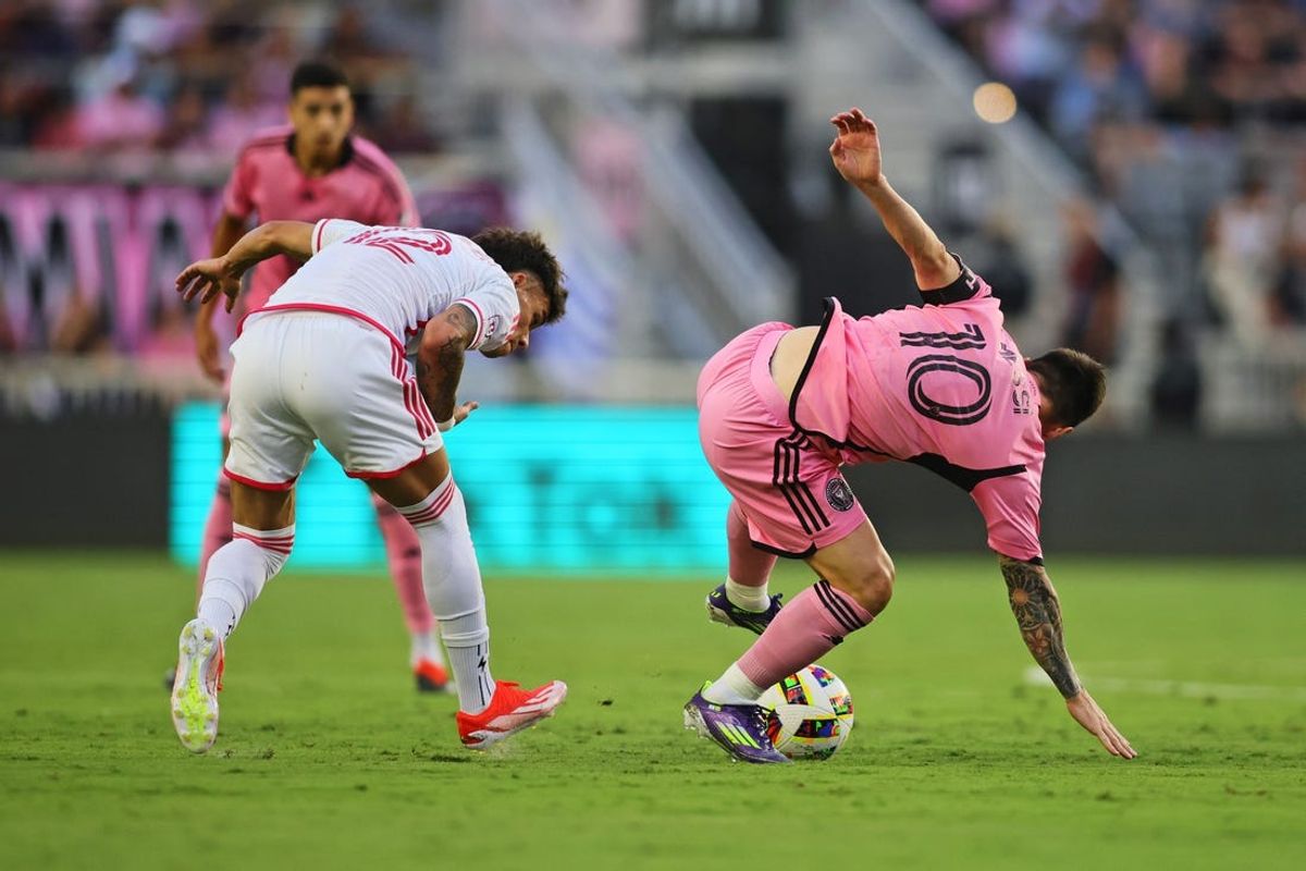 Jun 1, 2024; Fort Lauderdale, Florida, USA; St. Louis CITY SC midfielder Celio Pompeu (12) and Inter Miami CF forward Lionel Messi (10) collide during the first half at Chase Stadium. Mandatory Credit: Sam Navarro-USA TODAY Sports