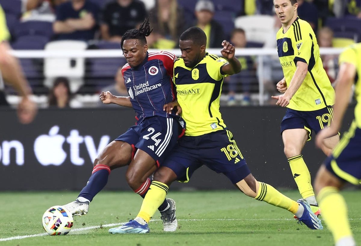 Jun 1, 2024; Nashville, Tennessee, USA; New England Revolution defender DeJuan Jones (24) passes against Nashville SC defender Shaq Moore (18) during the first half at Geodis Park. Mandatory Credit: Casey Gower-USA TODAY Sports