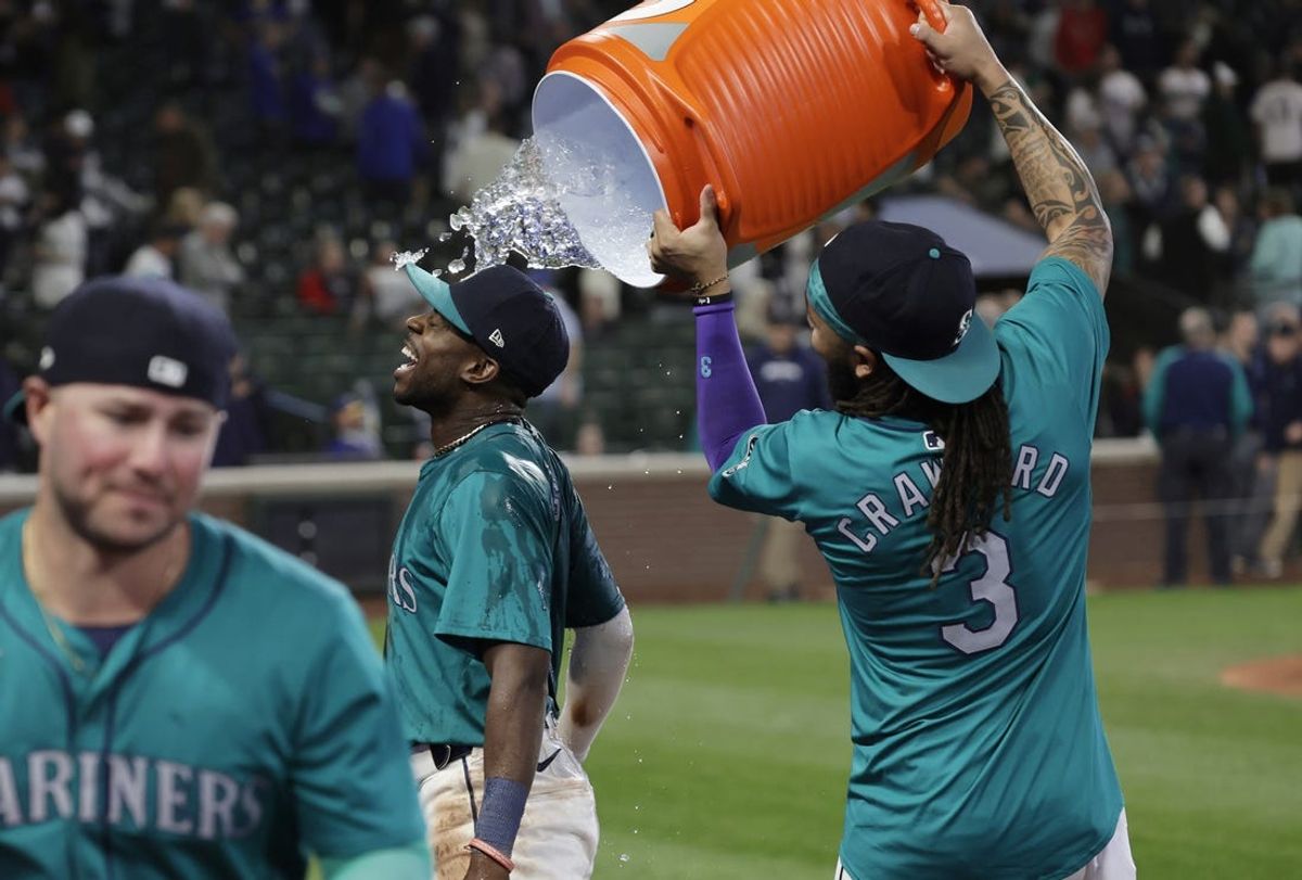 Jun 1, 2024; Seattle, Washington, USA;  Seattle Mariners shortstop J.P. Crawford (3) dumps ice water on Seattle Mariners second baseman Ryan Bliss after the 9-0 win over the Los Angeles Angels at T-Mobile Park. Mandatory Credit: John Froschauer-USA TODAY Sports