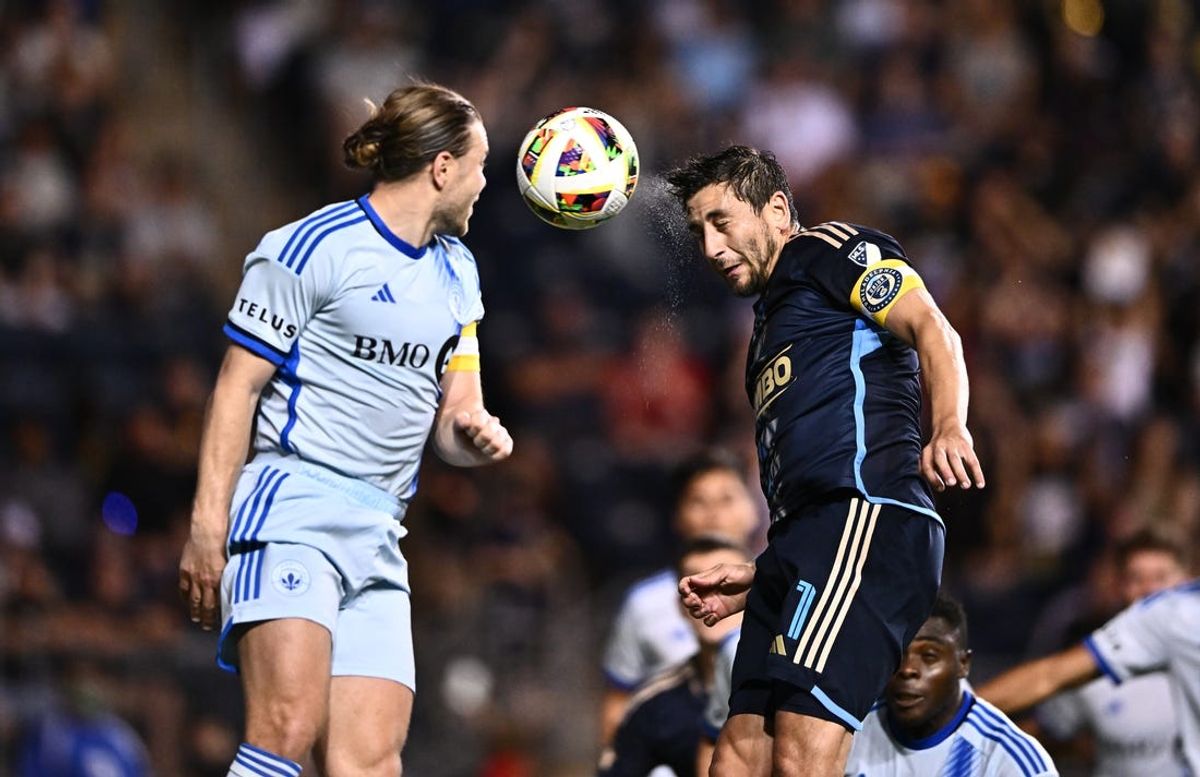 Jun 1, 2024; Philadelphia, Pennsylvania, USA; Philadelphia Union midfielder Alejandro Bedoya (11) heads the ball against CF Montreal midfielder Samuel Piette (6) in the second half at Subaru Park. Mandatory Credit: Kyle Ross-USA TODAY Sports