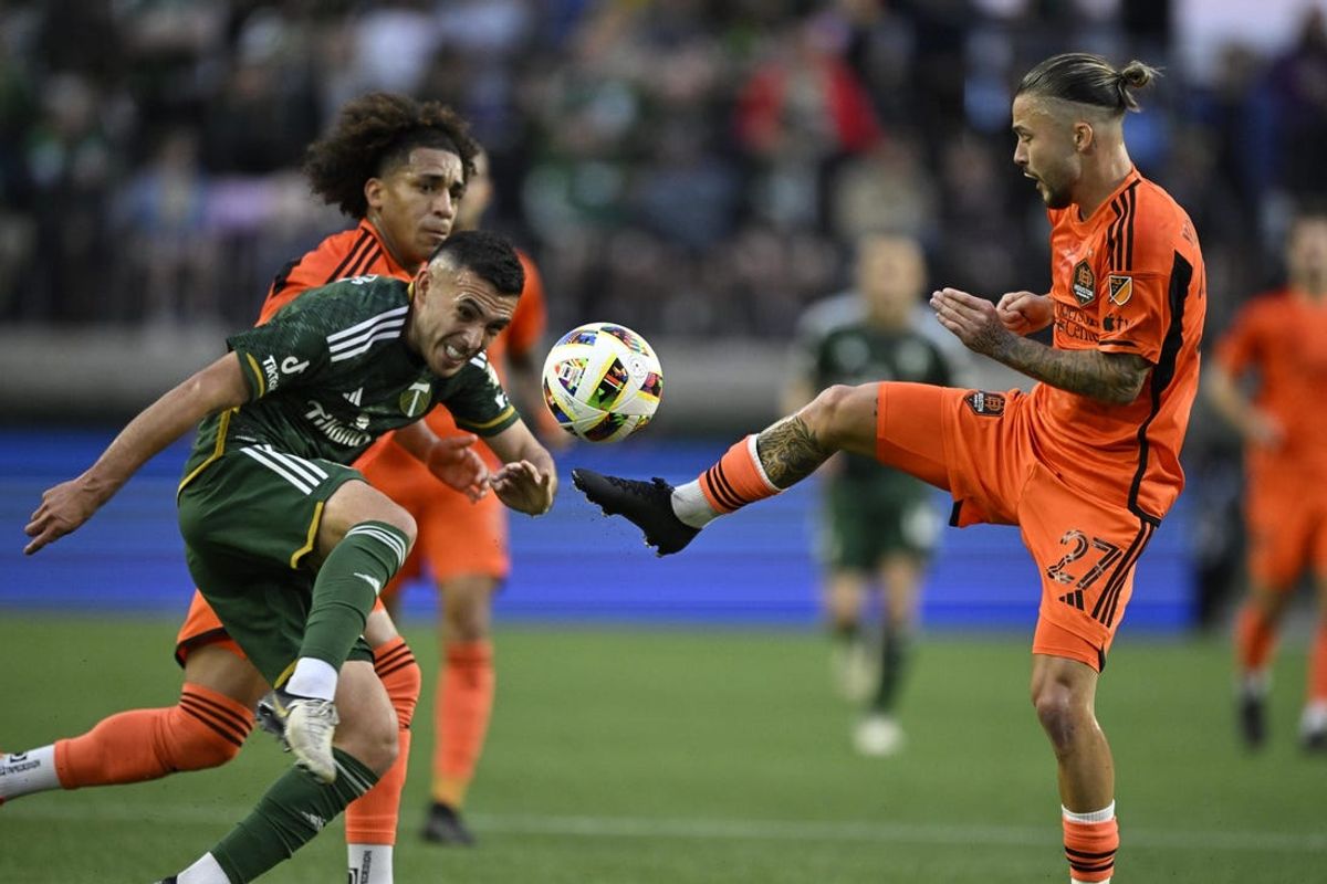 Jun 1, 2024; Portland, Oregon, USA; Houston Dynamo FC midfielder Sebastian Kowalczyk (27) and Portland Timbers midfielder Cristhian Paredes (22) fight for a loose ball during the first half at Providence Park. Mandatory Credit: Troy Wayrynen-USA TODAY Sports