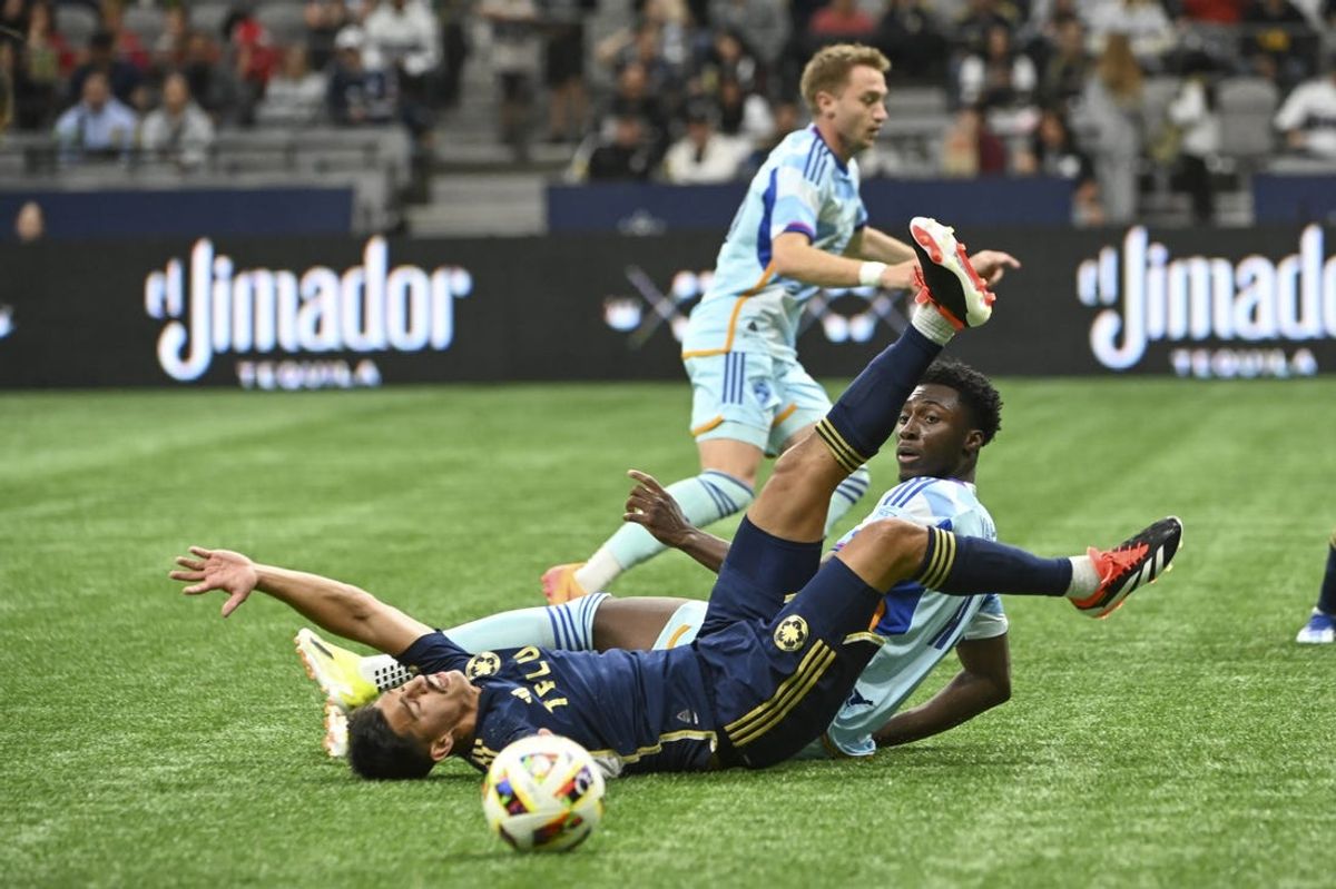 Jun 1, 2024; Vancouver, British Columbia, CAN; Vancouver Whitecaps FC defender Mathias Laborda (2) and Colorado Rapids forward Darren Yapi (77) collide during the first half at BC Place. Mandatory Credit: Simon Fearn-USA TODAY Sports