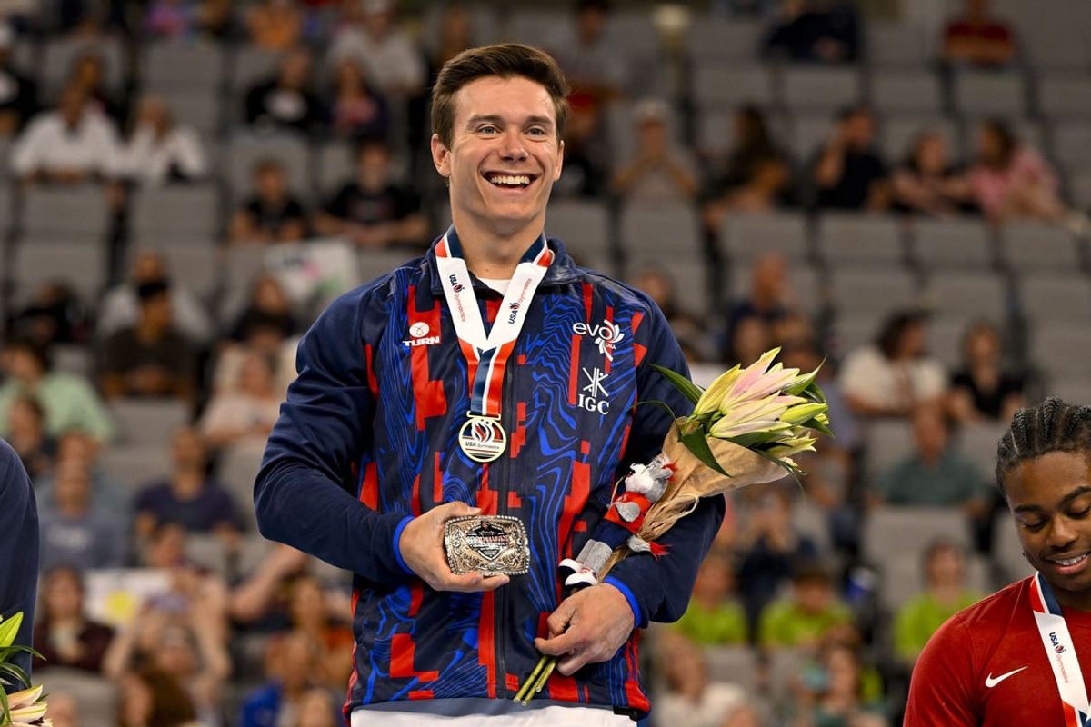 Jun 1, 2024; Fort Worth, Texas, USA; Brody Malone of EVO Gymnastics smiles to the crowd and holds up a champion belt buckle after he finishes in first place in the all around competition in the 2024 Xfinity U.S. Gymnastics Championships at Dickies Arena. Mandatory Credit: Jerome Miron-USA TODAY Sports