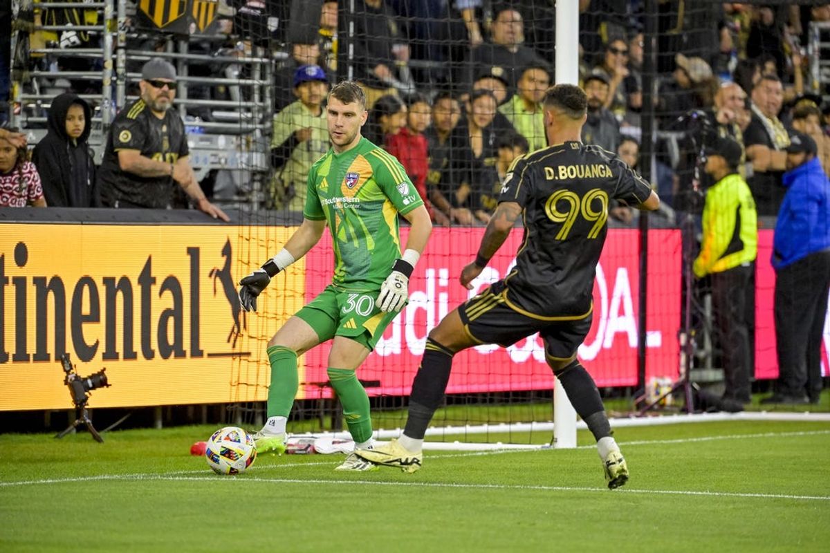Jun 1, 2024; Los Angeles, California, USA; FC Dallas goalkeeper Maarten Paes (30) and LAFC forward Denis Bouanga (99) battle for the ball during the first half at BMO Stadium. Mandatory Credit: Jayne Kamin-Oncea-USA TODAY Sports