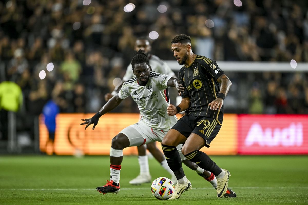 Jun 1, 2024; Los Angeles, California, USA; FC Dallas defender Ema Twumasi (22) and LAFC forward Denis Bouanga (99) battle for the ball during the first half at BMO Stadium. Mandatory Credit: Jonathan Hui-Imagn Images