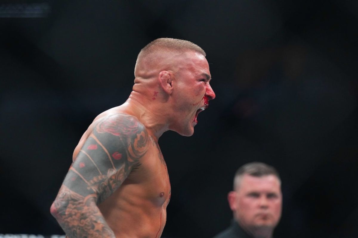 Jun 1, 2024; Newark, New Jersey, USA; Dustin Poirier (blue gloves) reacts during the fight against Islam Makhachev (red gloves) during UFC 302 at Prudential Center. Mandatory Credit: Joe Camporeale-Imagn Images