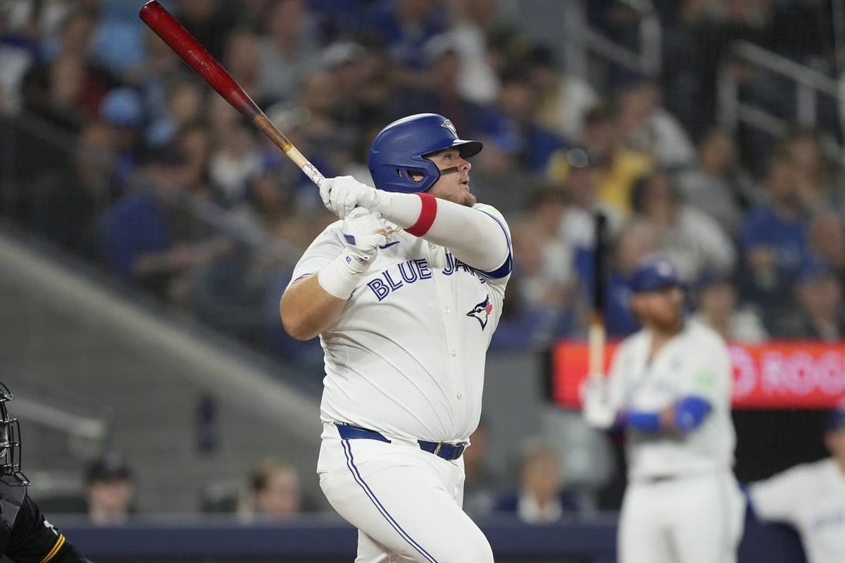 Jun 2, 2024; Toronto, Ontario, CAN; Toronto Blue Jays designated hitter Daniel Vogelbach (20) hits a two-run double against the Pittsburgh Pirates during the fifth inning at Rogers Centre. Mandatory Credit: John E. Sokolowski-USA TODAY Sports
