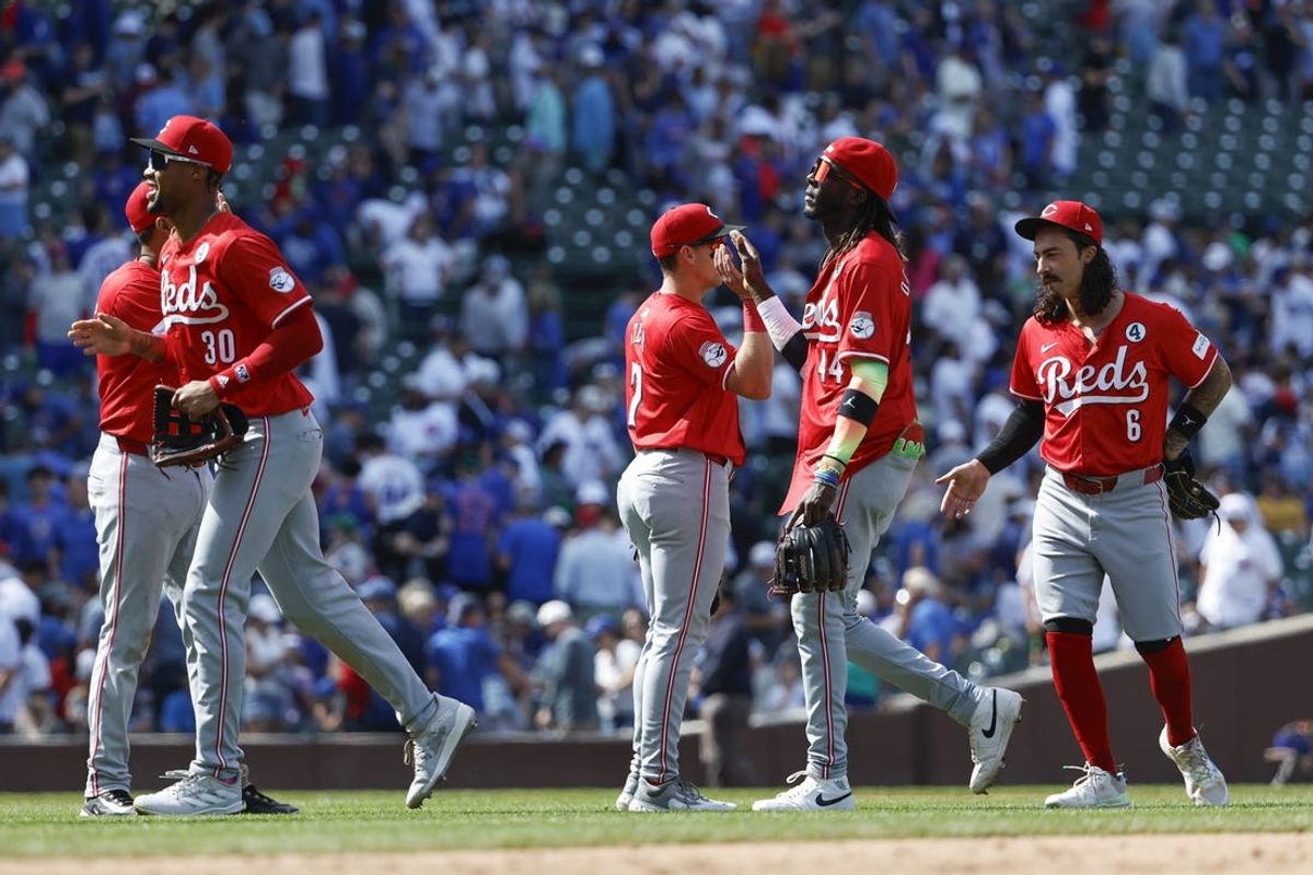 Jun 2, 2024; Chicago, Illinois, USA; Cincinnati Reds players celebrate after defeating the Chicago Cubs in a baseball game at Wrigley Field. Mandatory Credit: Kamil Krzaczynski-USA TODAY Sports