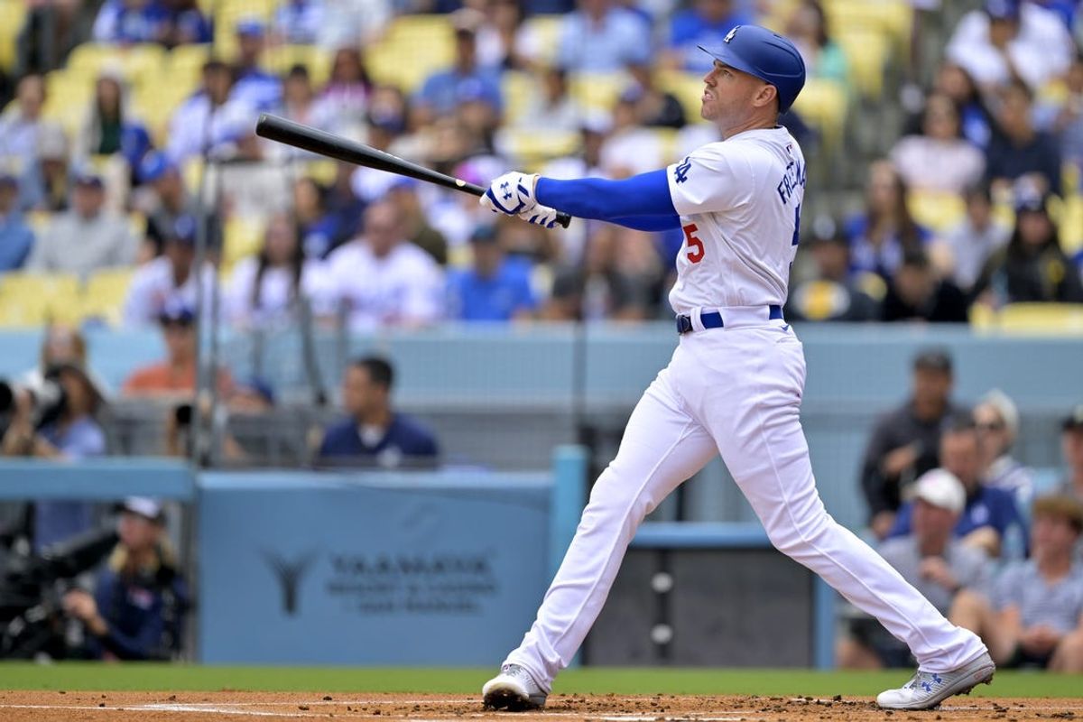 Jun 2, 2024; Los Angeles, California, USA;  Los Angeles Dodgers first base Freddie Freeman (5) hits a solo home run in the first inning against the Colorado Rockies at Dodger Stadium. Mandatory Credit: Jayne Kamin-Oncea-USA TODAY Sports