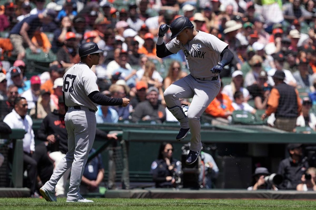 Jun 2, 2024; San Francisco, California, USA; New York Yankees right fielder Juan Soto (right) celebrates with third base coach Luis Rojas (67) after hitting a home run against the San Francisco Giants during the first inning at Oracle Park. Mandatory Credit: Darren Yamashita-USA TODAY Sports