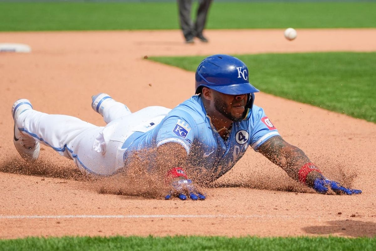 Jun 2, 2024; Kansas City, Missouri, USA; Kansas City Royals outfielder Nelson Velázquez (17) slides safely into third base after hitting a two run triple against the San Diego Padres in the ninth inning at Kauffman Stadium. Mandatory Credit: Denny Medley-USA TODAY Sports