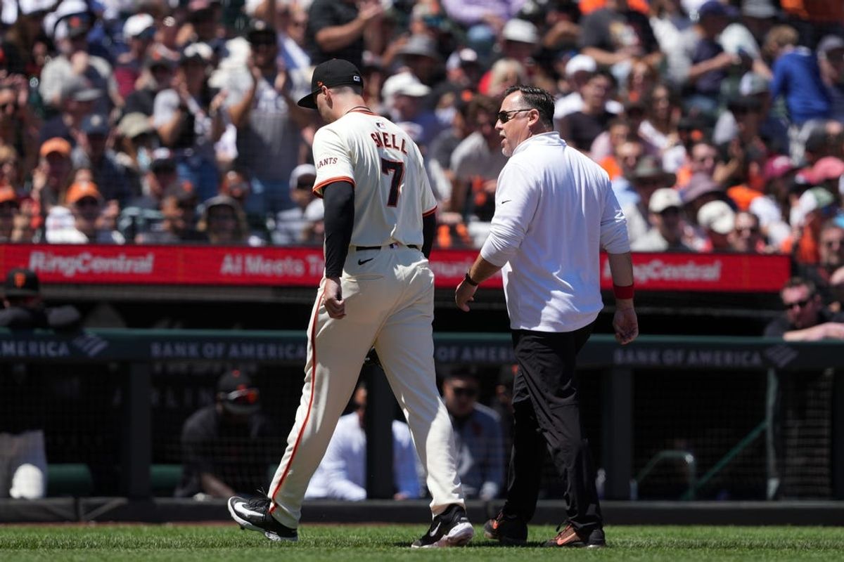Jun 2, 2024; San Francisco, California, USA; San Francisco Giants starting pitcher Blake Snell (7) walks off of the field with athletic trainer Dave Groeschner (right) during the fifth inning against the New York Yankees at Oracle Park. Mandatory Credit: Darren Yamashita-USA TODAY Sports