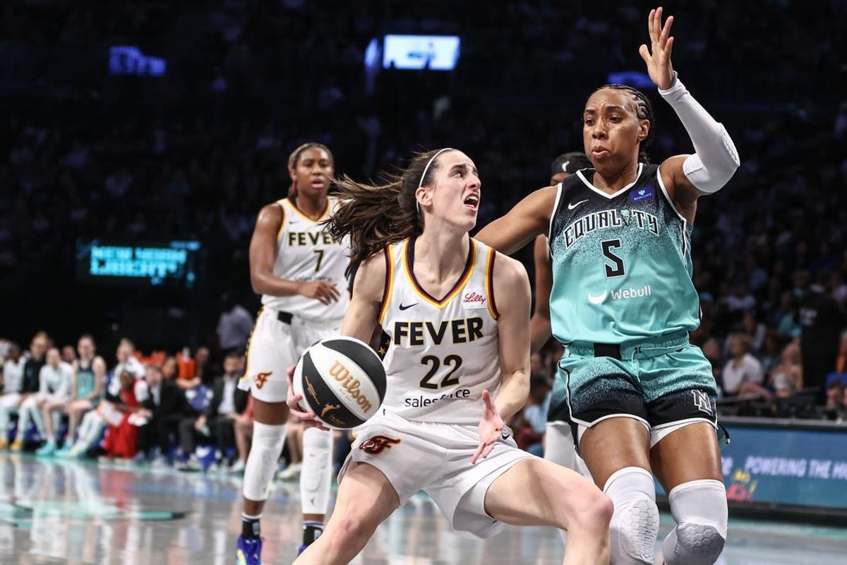 Jun 2, 2024; Brooklyn, New York, USA;  Indiana Fever guard Caitlin Clark (22) looks to drive past New York Liberty forward Kayla Thornton (5) in the second quarter at Barclays Center. Mandatory Credit: Wendell Cruz-USA TODAY Sports