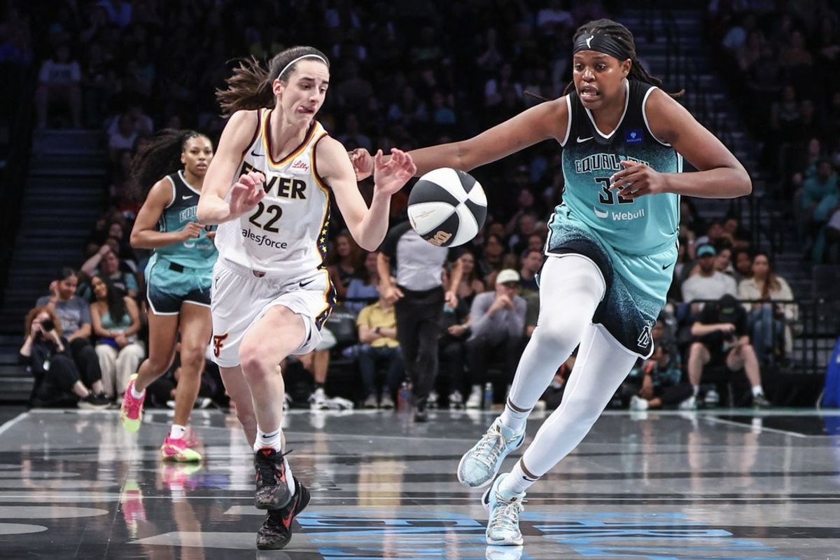 Jun 2, 2024; Brooklyn, New York, USA;  Indiana Fever guard Caitlin Clark (22) and New York Liberty forward Jonquel Jones (35) chase after a loose ball in the second quarter at Barclays Center. Mandatory Credit: Wendell Cruz-Imagn Images
