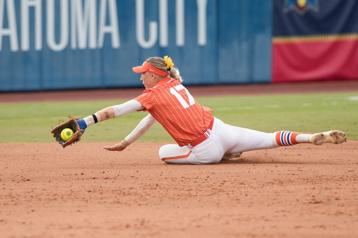 Jun 2, 2024; Oklahoma City, OK, USA; Florida Gators shortstop Skylar Wallace (17) makes a stop in the sixth inning against the Alabama Crimson Tide during a Women's College World Series softball losers bracket elimination game at Devon Park. Mandatory Credit: Brett Rojo-USA TODAY Sports