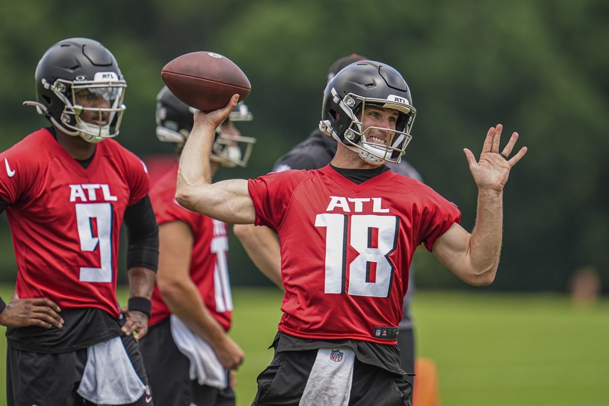 Jun 3, 2024; Atlanta, GA, USA; Atlanta Falcons quarterback Kirk Cousins (18) throws while quarterback Michael Penix Jr (9) watches on the field during Falcons OTA at the Falcons Training facility. Mandatory Credit: Dale Zanine-USA TODAY Sports