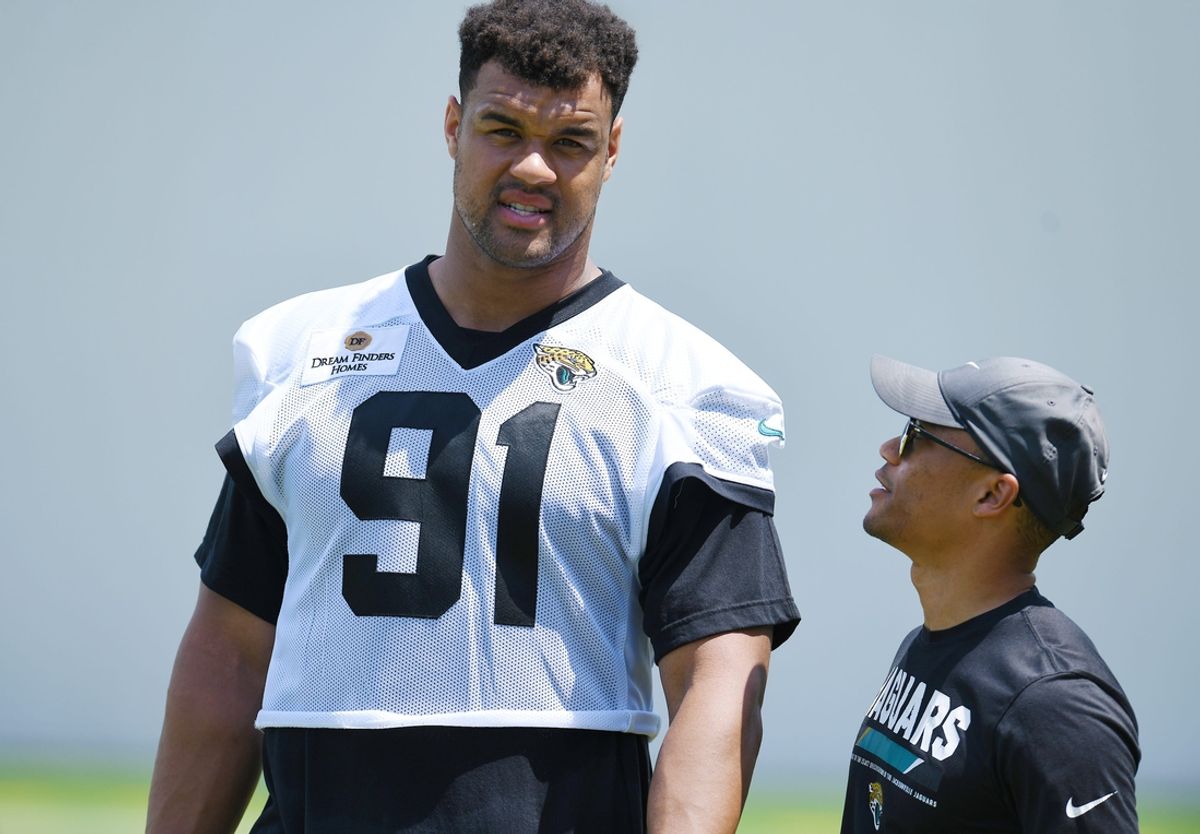 Jaguars director of football communications Dylan Morton talks with Jacksonville Jaguars defensive tackle Arik Armstead (91) at the end of the organized team activity session Monday, June 3, 2024 at EverBank Stadium's Miller Electric Center in Jacksonville, Fla.