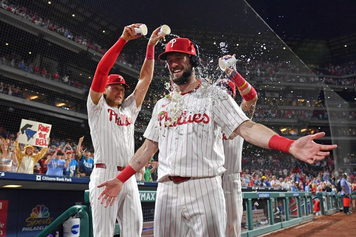 Jun 3, 2024; Philadelphia, Pennsylvania, USA; Philadelphia Phillies outfielder David Dahl (35) has water dumped on him by third base Alec Bohm (28) and second base Bryson Stott (5) after win against the Milwaukee Brewers during the seventh inning at Citizens Bank Park. Mandatory Credit: Eric Hartline-USA TODAY Sports