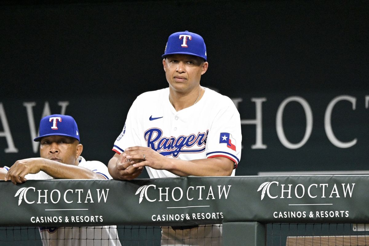 Jun 3, 2024; Arlington, Texas, USA; Texas Rangers associate manager Will Venable (83) watches from the dugout during the fourth inning against the Detroit Tigers at Globe Life Field. Venable fills in as acting manager for manager Bruce Bochy (not pictured) who misses game due to person reasons. Mandatory Credit: Jerome Miron-Imagn Images