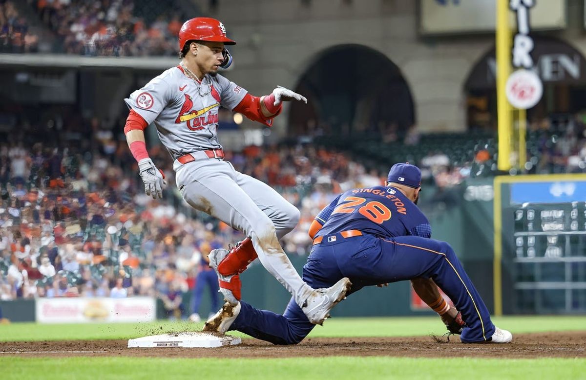 Jun 3, 2024; Houston, Texas, USA; St. Louis Cardinals shortstop Masyn Winn (0) is safe with an infield single as Houston Astros first baseman Jon Singleton (28) fields a throw during the fourth inning at Minute Maid Park. Mandatory Credit: Troy Taormina-USA TODAY Sports
