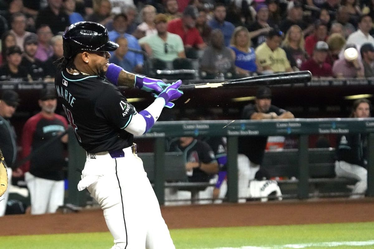Jun 3, 2024; Phoenix, Arizona, USA; Arizona Diamondbacks second base Ketel Marte (4) hits a single against the San Francisco Giants in the first inning at Chase Field. Mandatory Credit: Rick Scuteri-USA TODAY Sports
