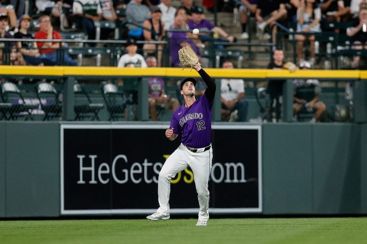 Jun 3, 2024; Denver, Colorado, USA; Colorado Rockies left fielder Sean Bouchard (12) makes a catch for an out in the sixth inning against the Cincinnati Reds at Coors Field. Mandatory Credit: Isaiah J. Downing-USA TODAY Sports