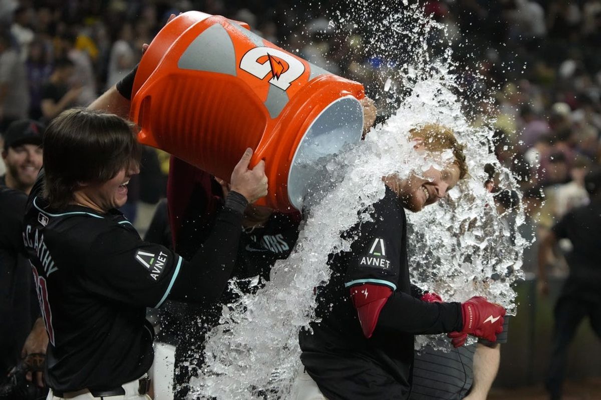 Jun 3, 2024; Phoenix, Arizona, USA; Arizona Diamondbacks outfielder Pavin Smith (26) gets water dunk after hitting a two run home run against the San Francisco Giants in the ninth inning at Chase Field. Mandatory Credit: Rick Scuteri-USA TODAY Sports