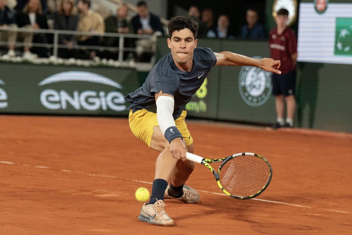 Jun 4, 2024; Paris, France; Carlos Alcaraz of Spain returns a shot during his match against Stefanos Tsitsipas of Greece on day 10 of Roland Garros at Stade Roland Garros. Mandatory Credit: Susan Mullane-USA TODAY Sports