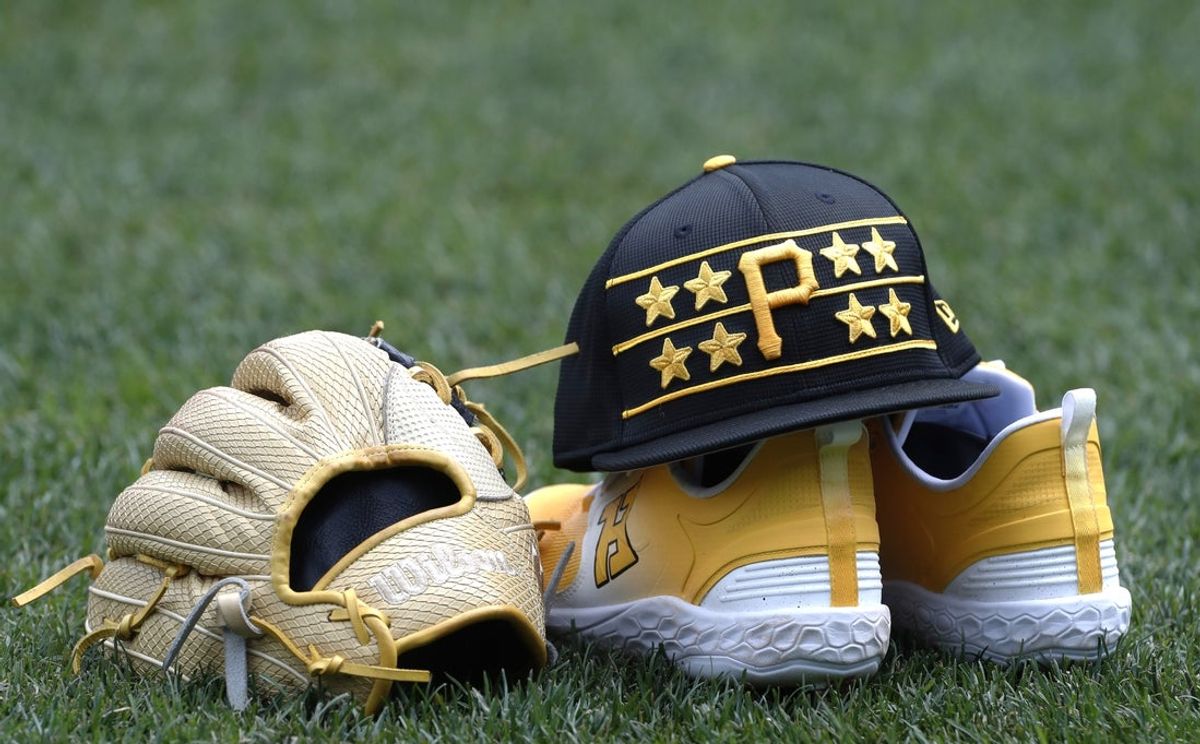 Jun 4, 2024; Pittsburgh, Pennsylvania, USA;  A cap shoes and glove belonging to Pittsburgh Pirates third base Ke'Bryan Hayes on the field before the game against the Los Angeles Dodgers at PNC Park. Mandatory Credit: Charles LeClaire-Imagn Images