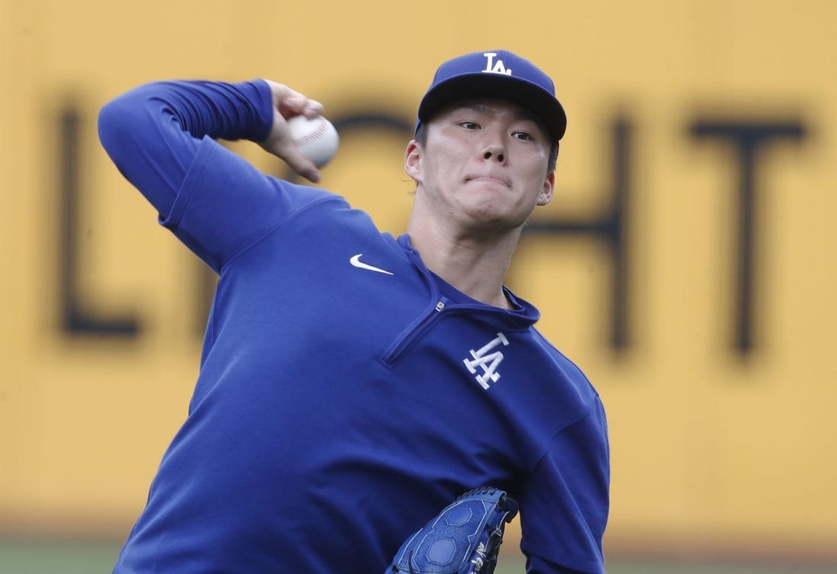 Jun 4, 2024; Pittsburgh, Pennsylvania, USA;  Los Angeles Dodgers pitcher Yoshinobu Yamamoto throws in the outfield before the game against the Pittsburgh Pirates at PNC Park. Mandatory Credit: Charles LeClaire-USA TODAY Sports