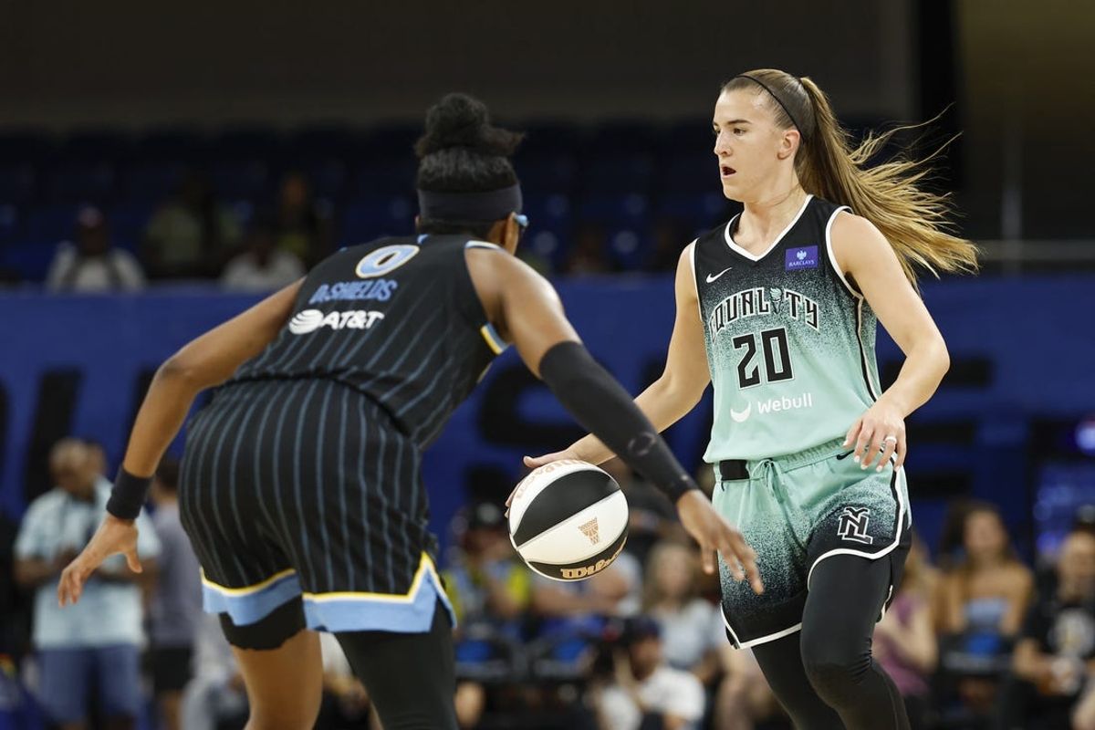 Jun 4, 2024; Chicago, Illinois, USA; New York Liberty guard Sabrina Ionescu (20) brings the ball up court against Chicago Sky guard Diamond DeShields (0) during the first half of a WNBA game at Wintrust Arena. Mandatory Credit: Kamil Krzaczynski-USA TODAY Sports