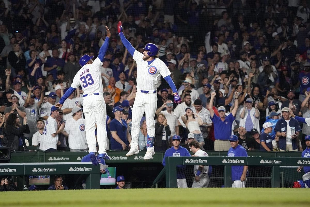 Jun 4, 2024; Chicago, Illinois, USA; Chicago Cubs pinch-hitter Patrick Wisdom (16) is greeted by Chicago Cubs third base coach Willie Harris (33) after hitting a two-run home run against the Chicago White Sox during the sixth inning at Wrigley Field. Mandatory Credit: David Banks-USA TODAY Sports