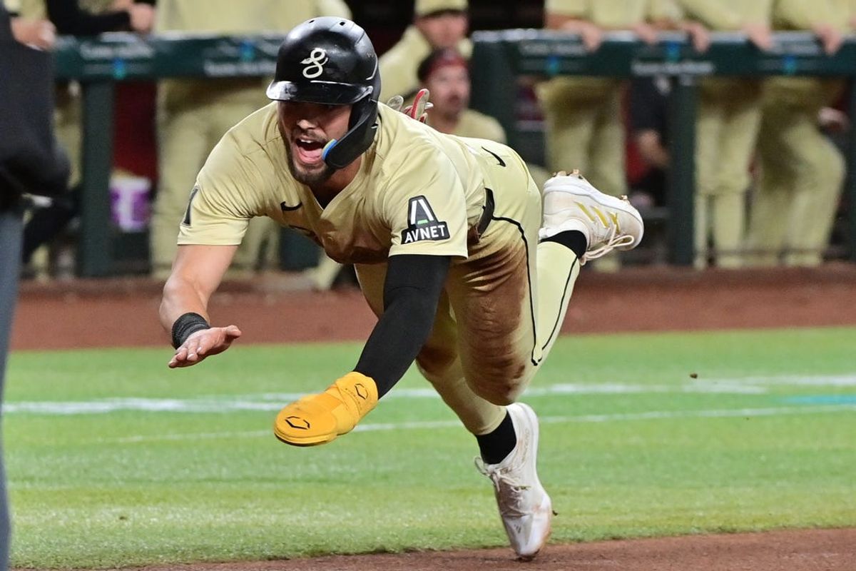 Jun 4, 2024; Phoenix, Arizona, USA; Arizona Diamondbacks shortstop Blaze Alexander (9) dives to score in the third inning against the San Francisco Giants at Chase Field. Mandatory Credit: Matt Kartozian-USA TODAY Sports