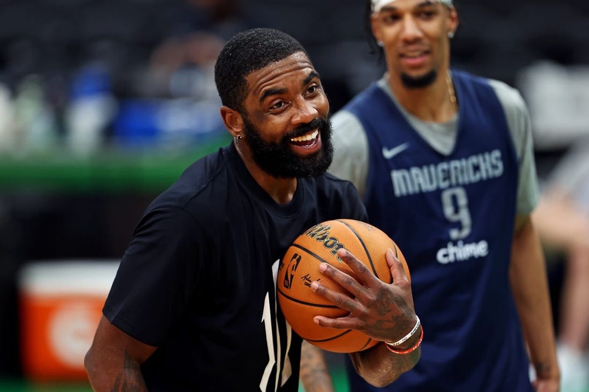 Jun 5, 2024; Boston, MA, USA;  Dallas Mavericks guard Kyrie Irving (11) and guard A.J. Lawson (9) laugh with teammates during the NBA Finals Media Day at TD Garden. Mandatory Credit: Peter Casey-USA TODAY Sports