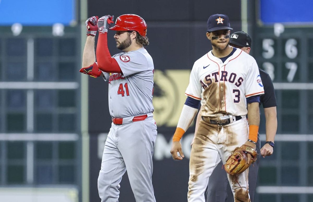 Jun 5, 2024; Houston, Texas, USA; Houston Astros shortstop Jeremy Pena (3) looks on and St. Louis Cardinals right fielder Alec Burleson (41) celebrates after hitting an RBI double during the fifth inning at Minute Maid Park. Mandatory Credit: Troy Taormina-USA TODAY Sports