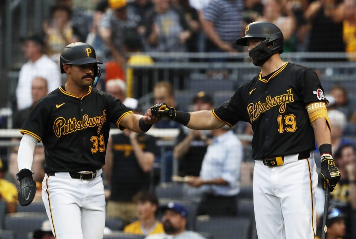 Jun 5, 2024; Pittsburgh, Pennsylvania, USA;  Pittsburgh Pirates shortstop Nick Gonzales (39) celebrates with second baseman Jared Triolo (19) after Gonzales scored a run against the Los Angeles Dodgers during the second inning at PNC Park. Mandatory Credit: Charles LeClaire-USA TODAY Sports